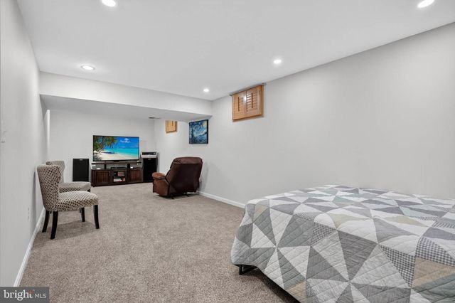 a bedroom with furniture and a flat screen tv