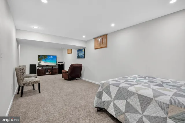 a bedroom with furniture and a flat screen tv