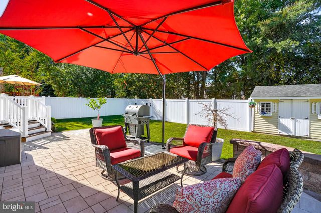 an outdoor sitting area with furniture and umbrella