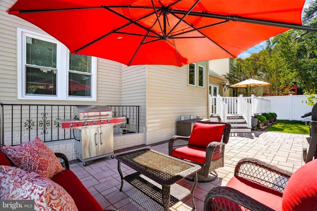 a view of a patio with a dining table and chairs under an umbrella
