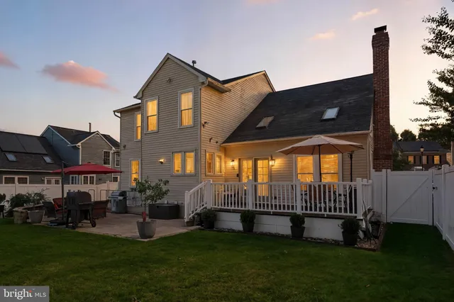 a view of a house with a yard and deck