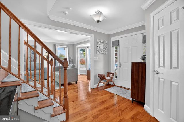 a view of an entryway with wooden floor and livingroom view