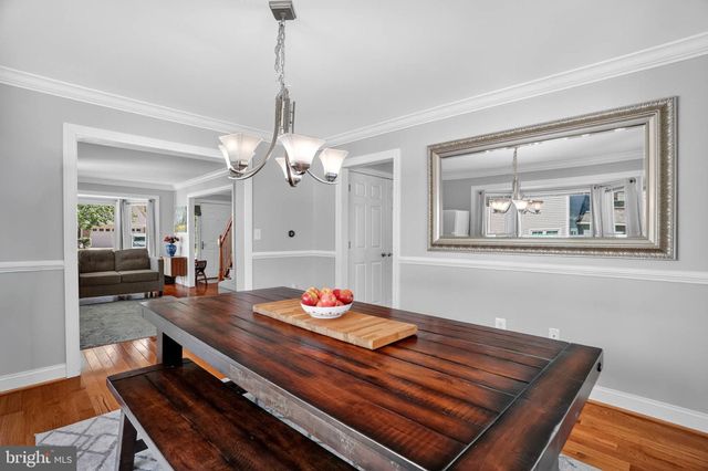 a living room with dining table and wooden floor