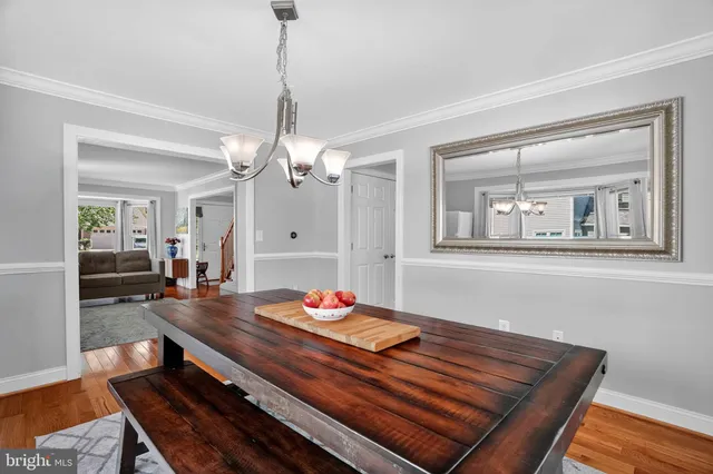 a living room with dining table and wooden floor