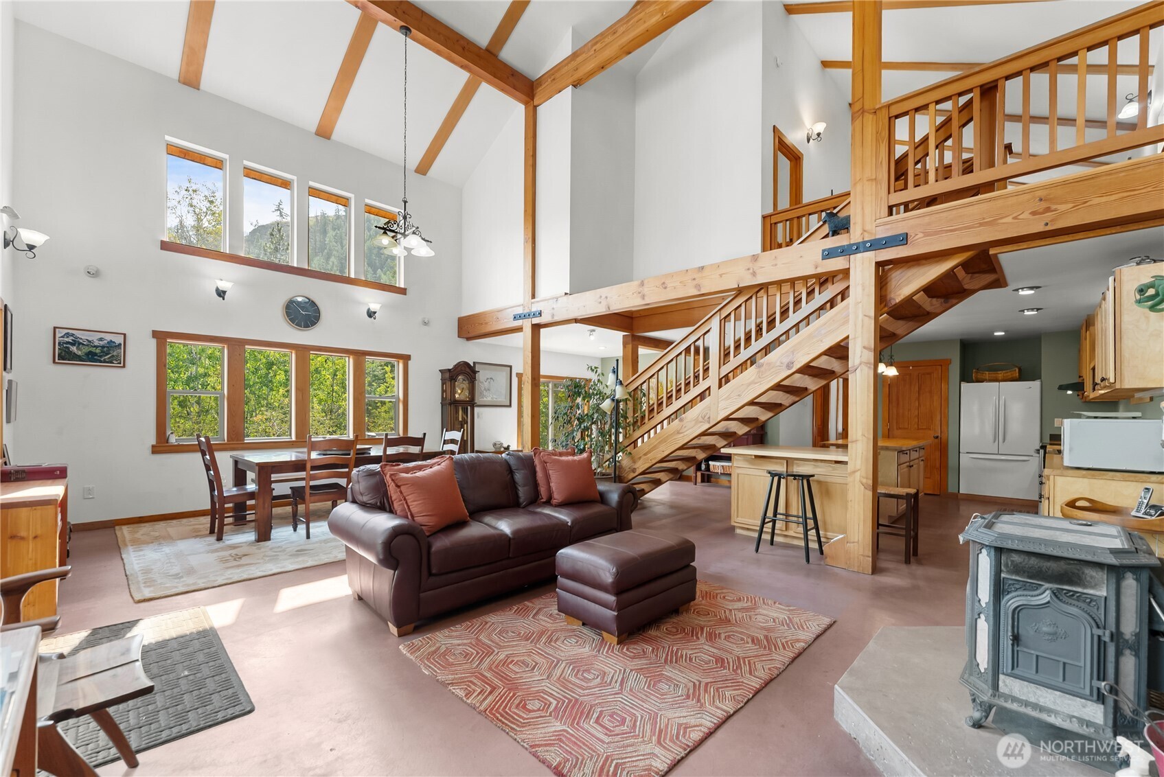 96 Alder Creek Road Twisp, WA 98856 - Photo 6 of 40 a living room with furniture a fireplace and a large window
