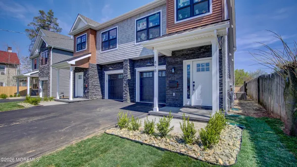 front view of a brick house with a yard