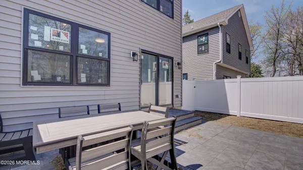a backyard of a house with table and chairs