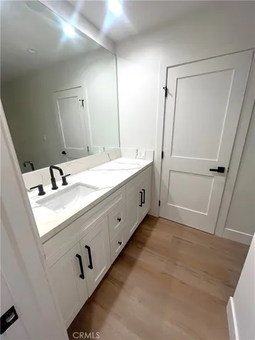 a bathroom with a double vanity sink and a mirror