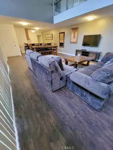 a room with wooden floor table and chairs