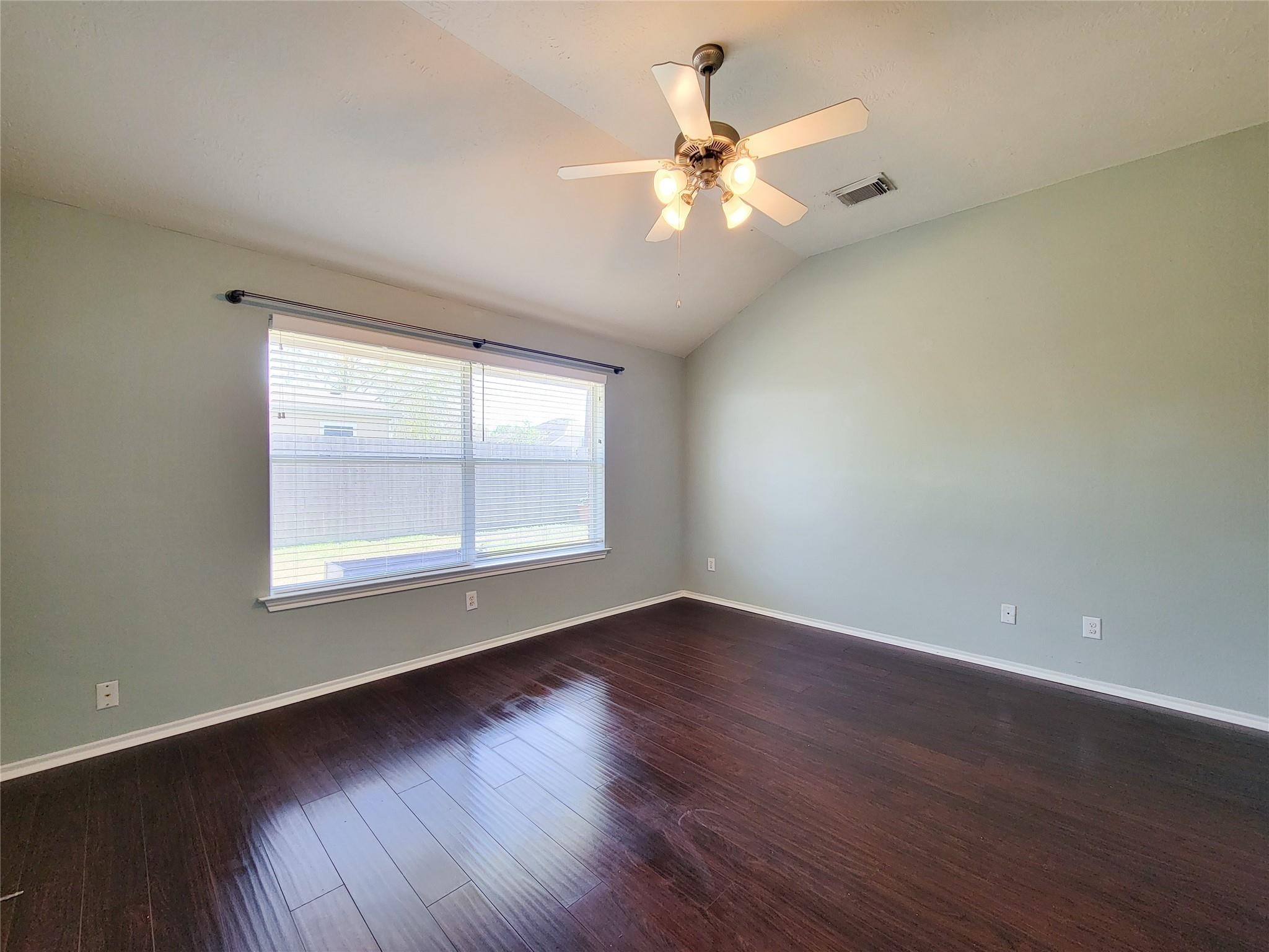 21722 Dimmett Way Spring, TX 77388 - Photo 12 of 38 a view of an empty room with wooden floor and a window