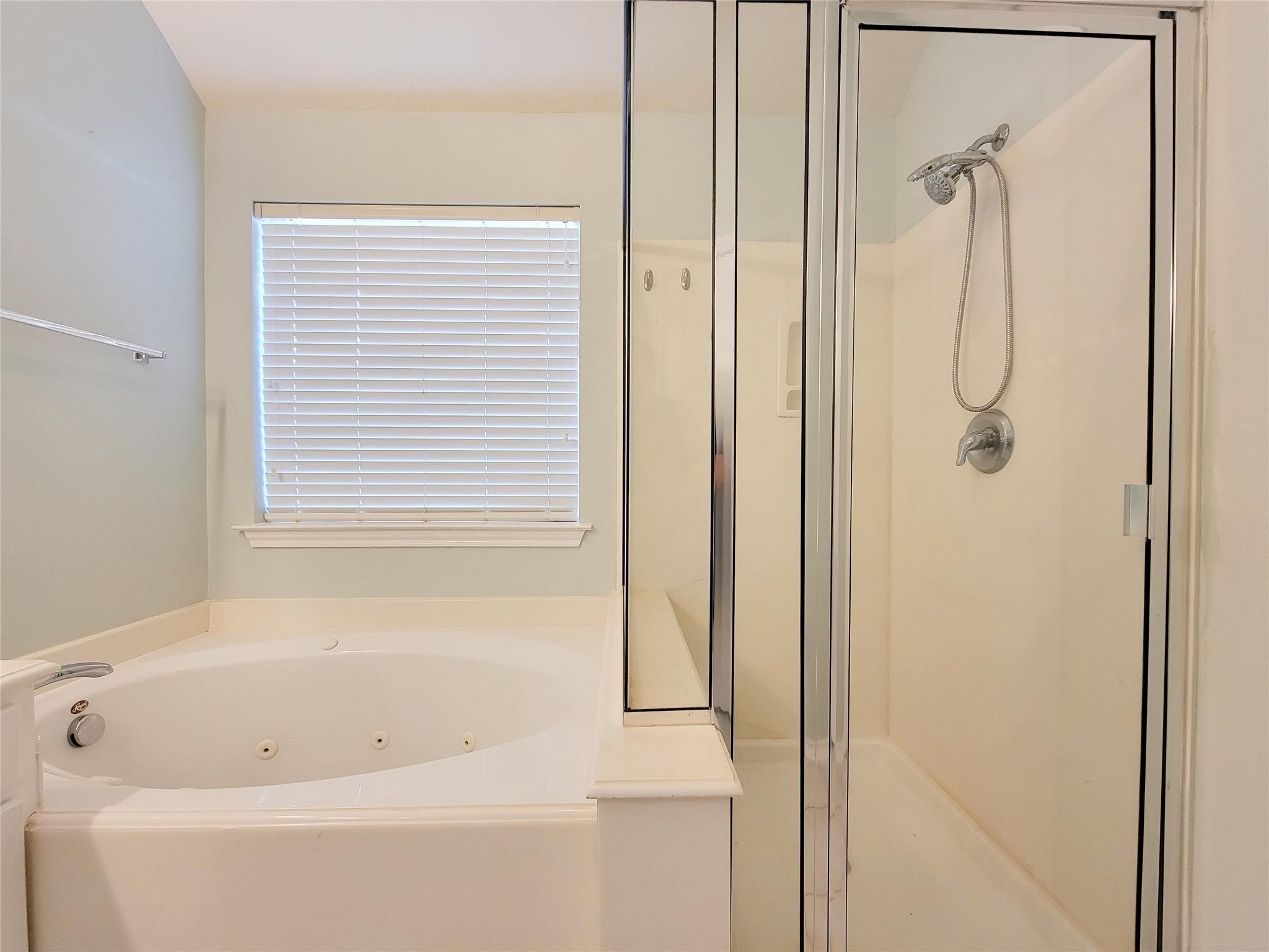 21722 Dimmett Way Spring, TX 77388 - Photo 18 of 38 a bathroom with a bath tub and a shower