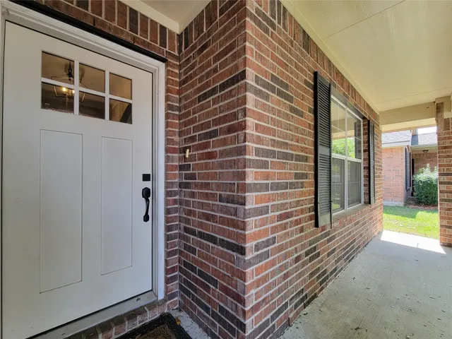 a view of a house with a door and a balcony