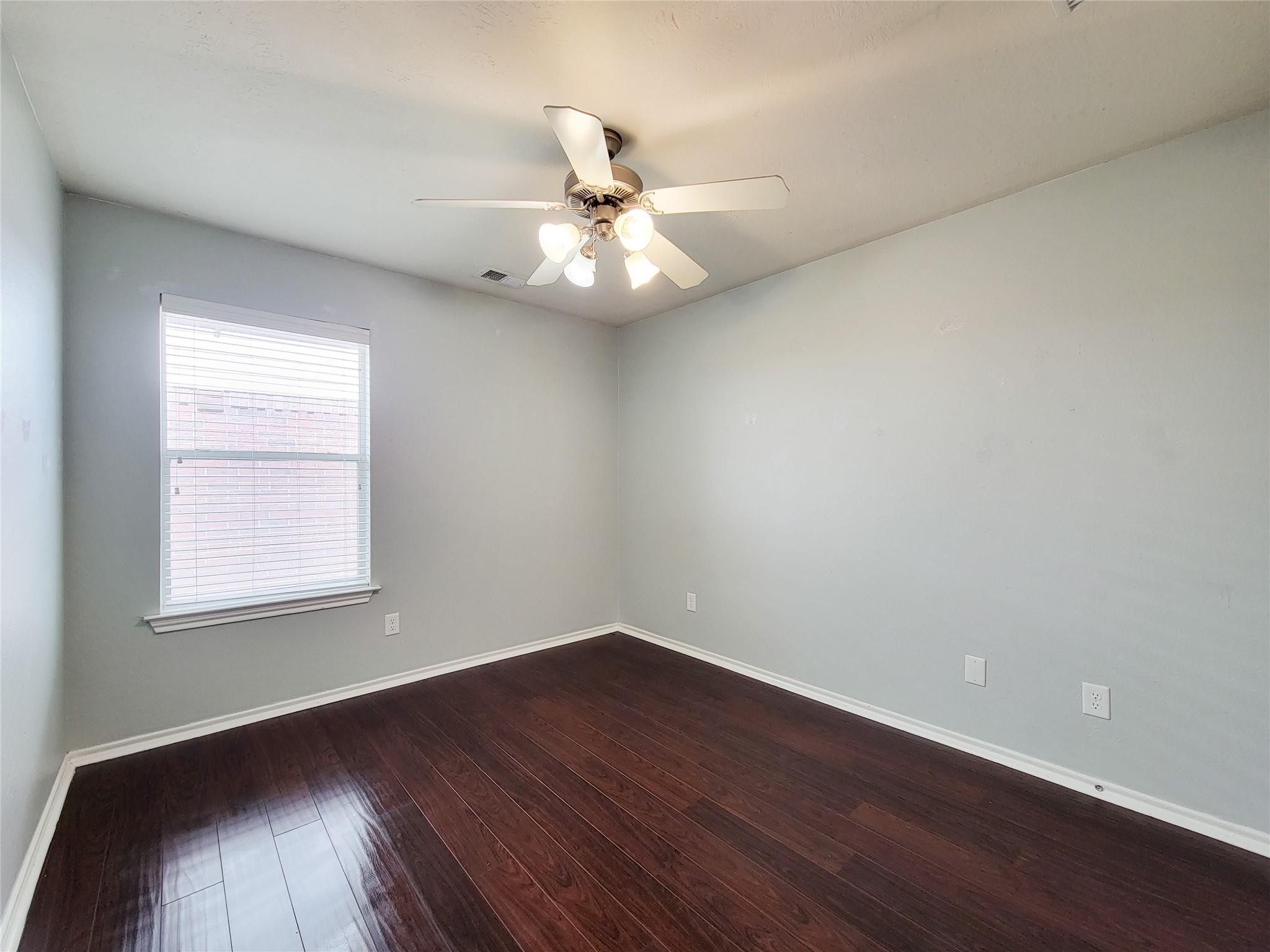 21722 Dimmett Way Spring, TX 77388 - Photo 24 of 38 an empty room with wooden floor fan and windows