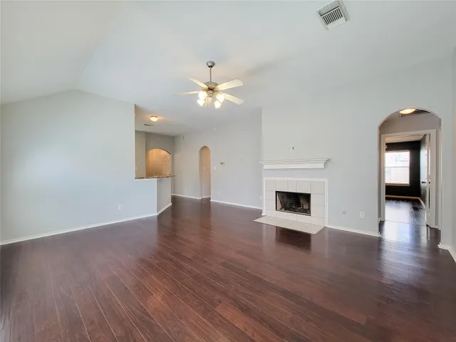 a view of a room with wooden floor and a fireplace