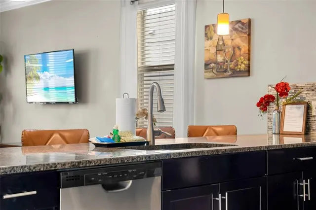 a blue kitchen with a sink and a wooden floor
