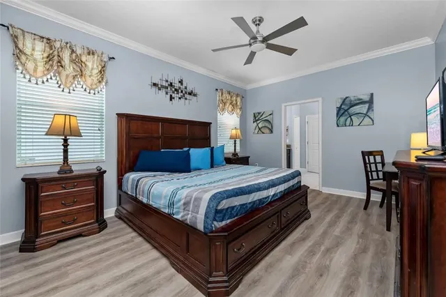 a bedroom with a bed and a chandelier