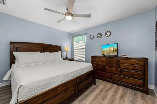 a bed room with a bed and a television