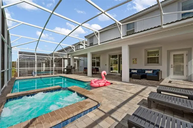 a view of an house with backyard porch and furniture