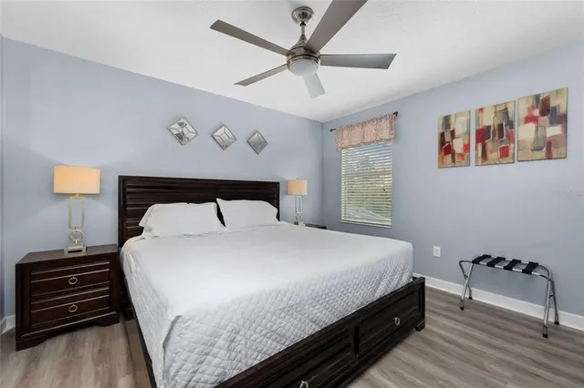a bedroom with a bed and a tv on a dresser