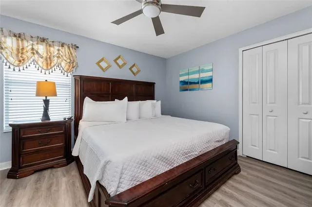 a bed sitting in a bedroom next to a window