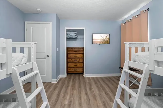 a view of wooden floor and windows in a room