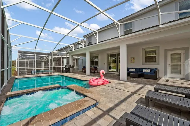 a view of an house with backyard porch and furniture