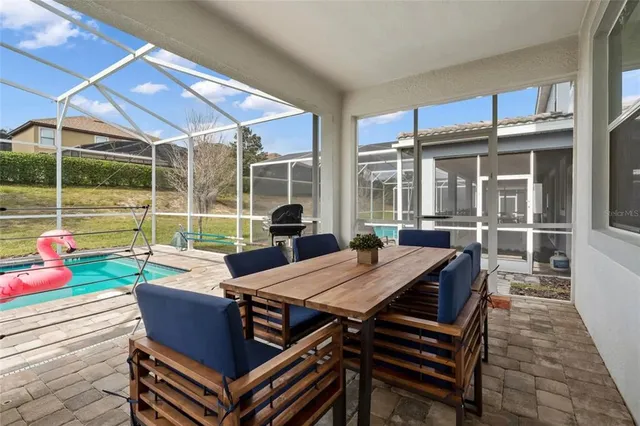 a view of a patio with table and chairs and potted plants