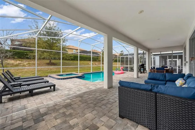 a living room with furniture a dining table and a large window