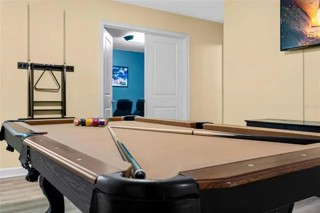 a room with a table chairs and windows