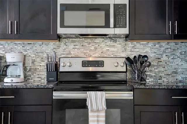a kitchen with a stove and cabinets