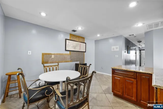 a bathroom with a granite countertop toilet sink and mirror
