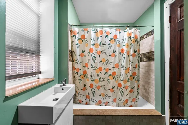 a bathroom with a shower curtain and a sink