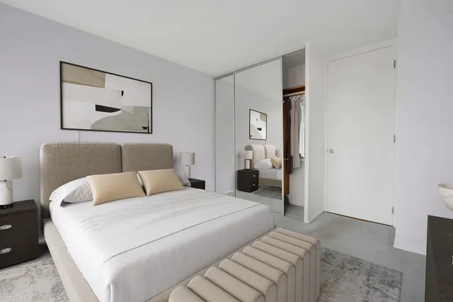 a bedroom with a bed and a painting on the wall