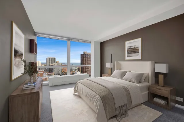 a bedroom with a bed couch and a large window