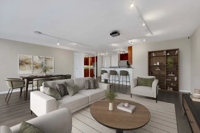 a living room with furniture kitchen view and a table