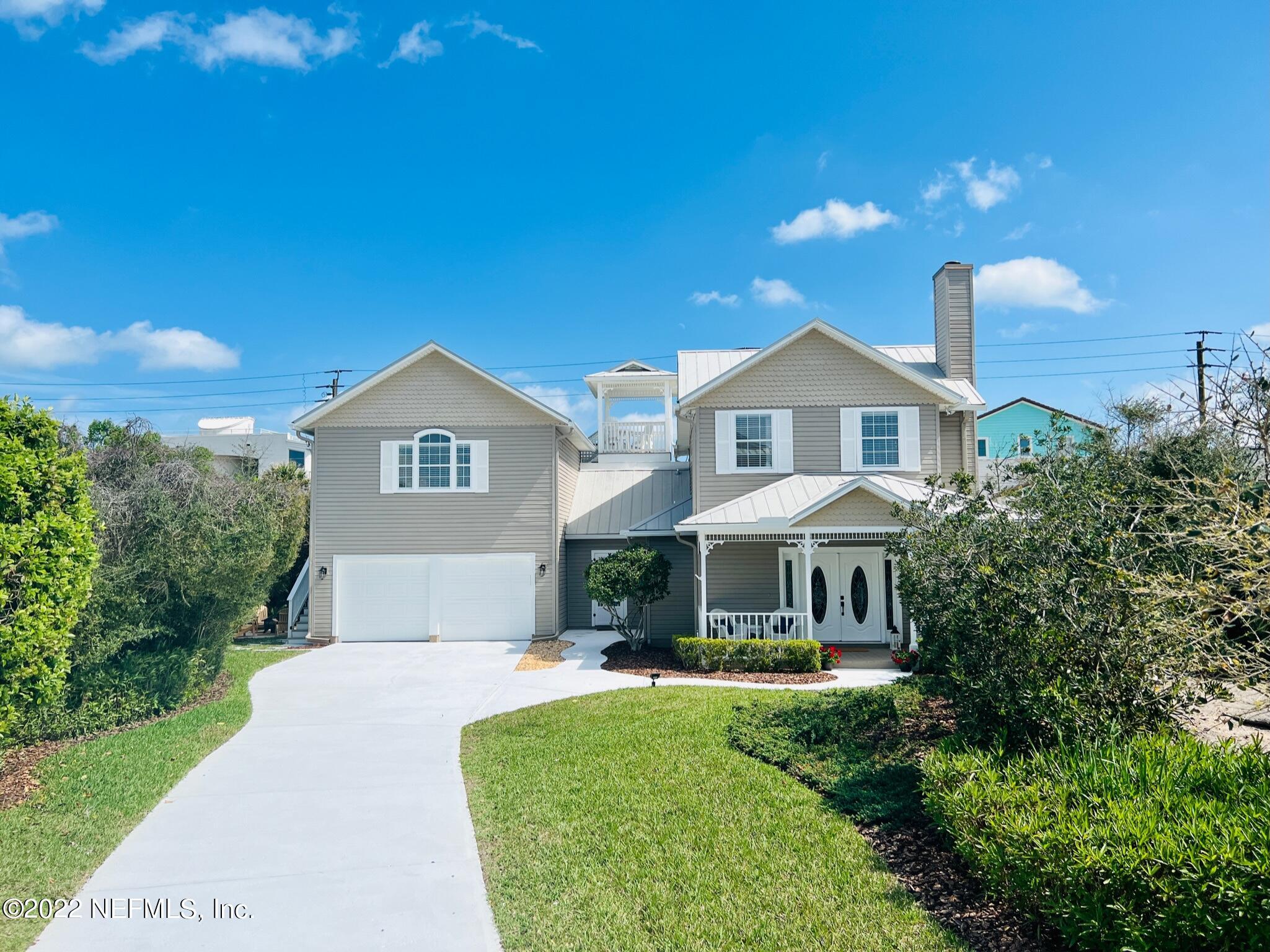 a front view of a house with yard and green space