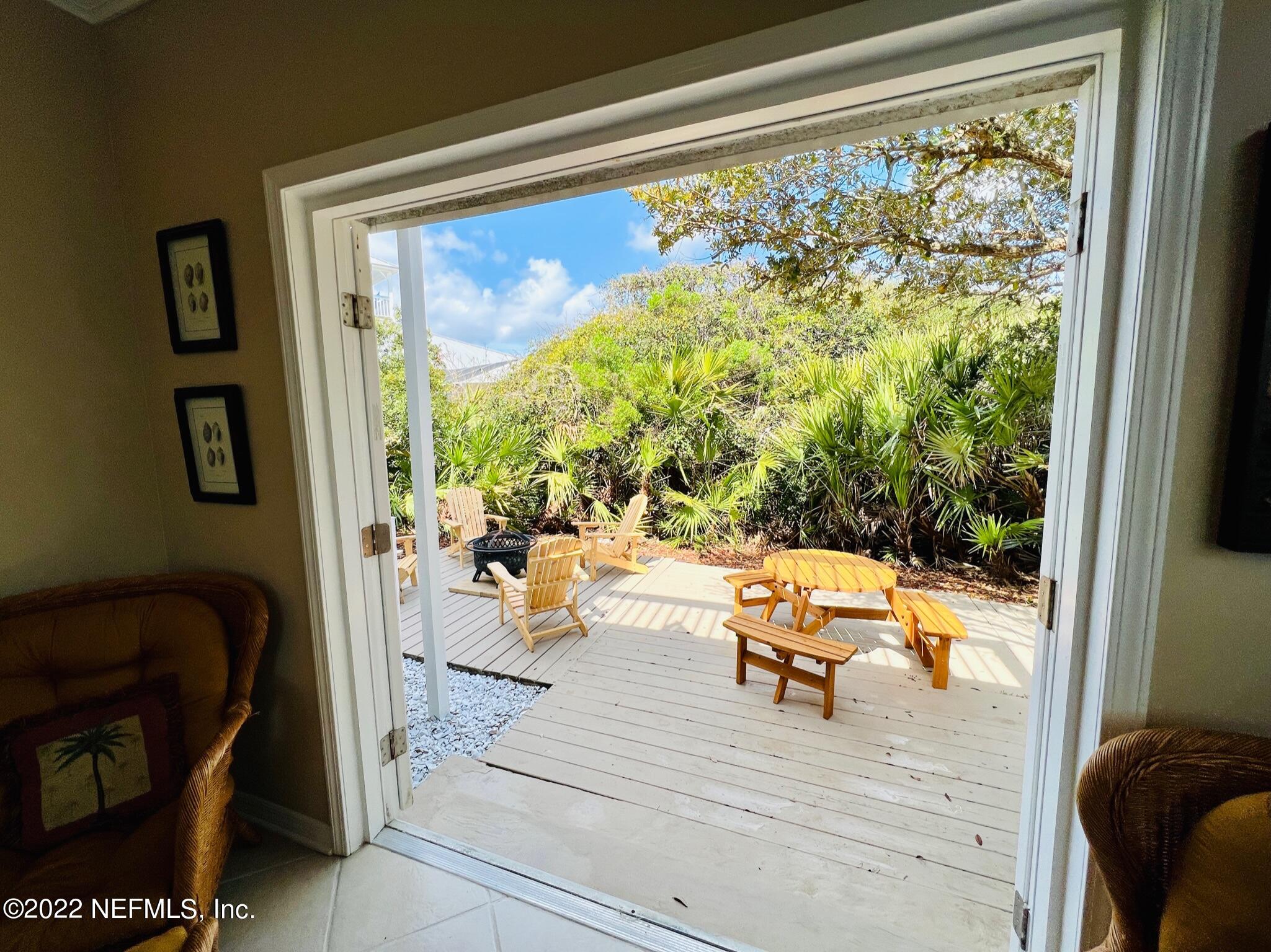 212 Gull Circle Ponte Vedra Beach, FL 32082 - Photo 19 of 49 a view of a living room and dining room with a floor to ceiling window