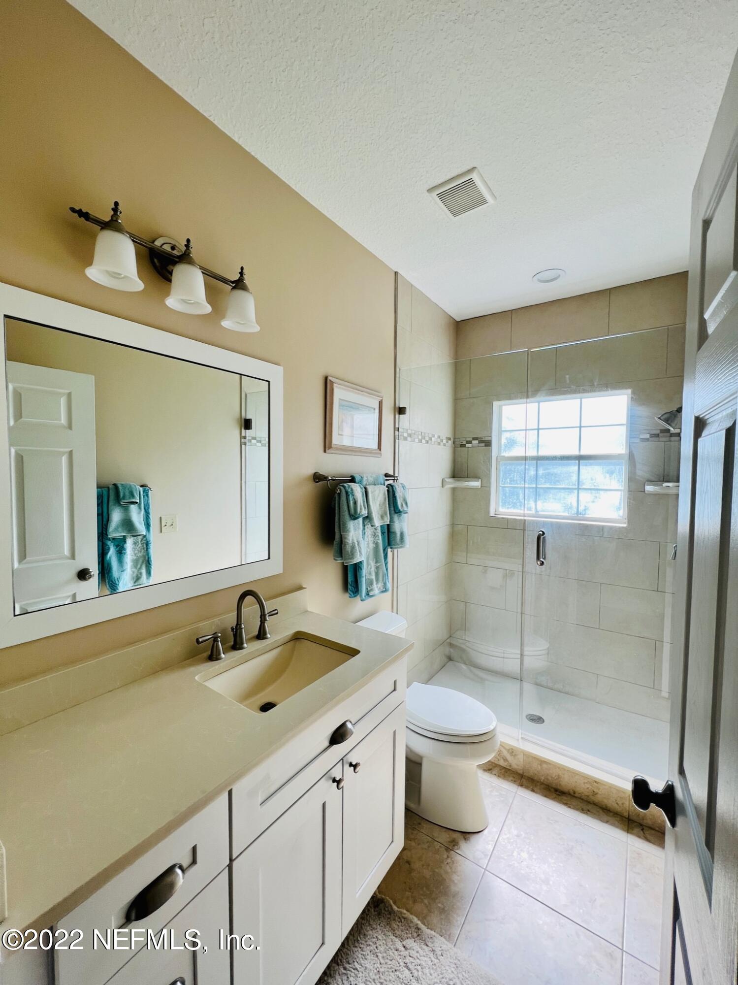 212 Gull Circle Ponte Vedra Beach, FL 32082 - Photo 32 of 49 a bathroom with a double vanity sink toilet mirror and shower