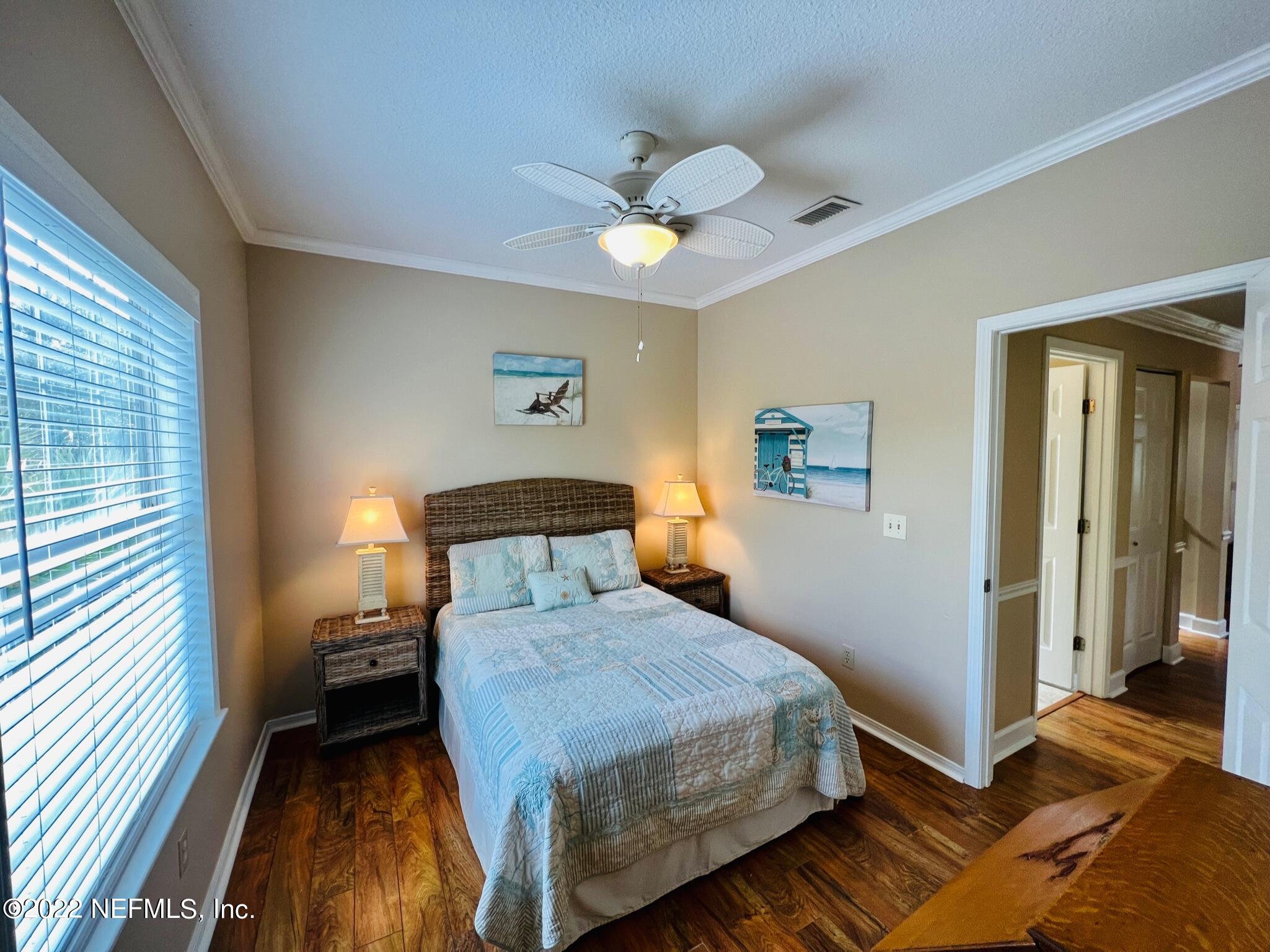 212 Gull Circle Ponte Vedra Beach, FL 32082 - Photo 33 of 49 a bedroom with a bed and a chandelier