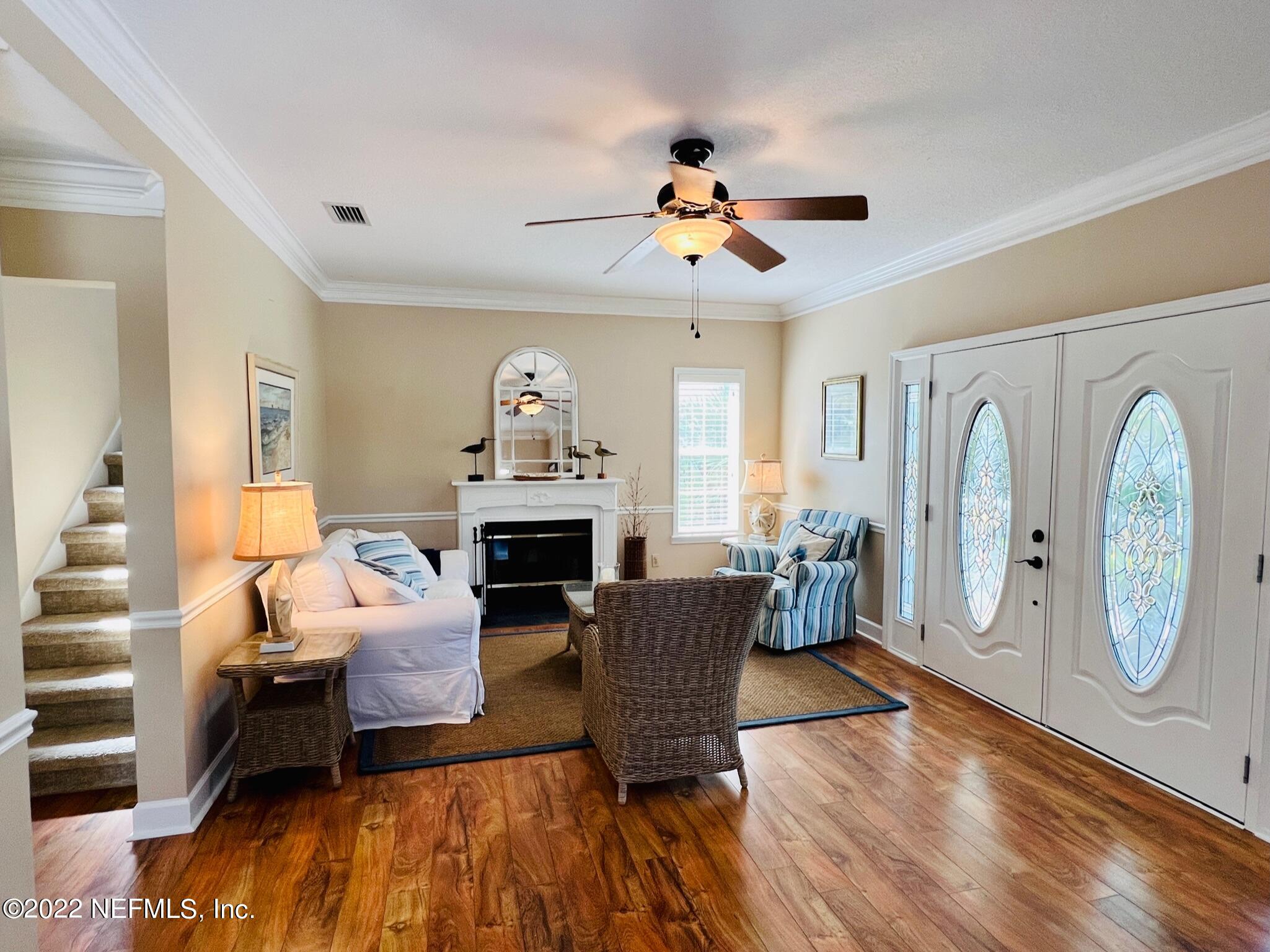 212 Gull Circle Ponte Vedra Beach, FL 32082 - Photo 8 of 49 a living room with furniture a fireplace and a chandelier