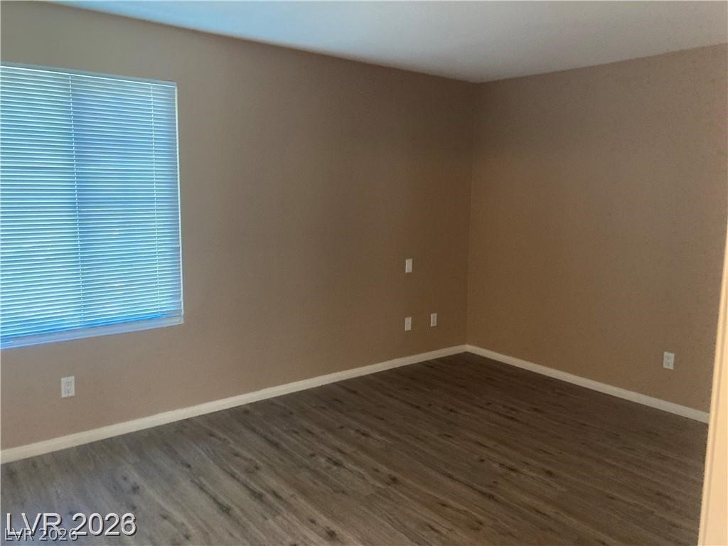 3145 East Flamingo Road, Unit 2100 Las Vegas, NV 89121 - Photo 19 of 34 Hardwood-style flooring extends through this room, illuminated by natural light from a window with blinds.