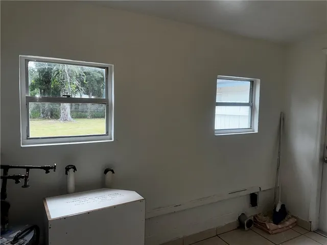 a bathroom with a sink toilet and window