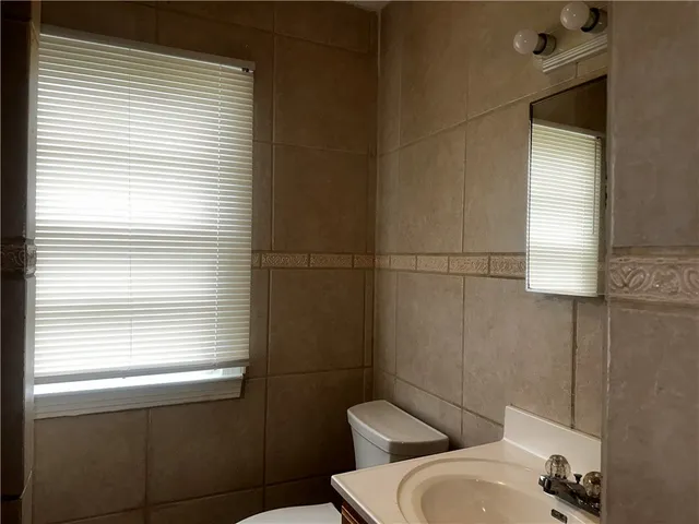 a bathroom with a toilet and a sink