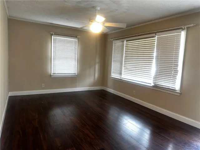 a kitchen with granite countertop a sink and wooden cabinets
