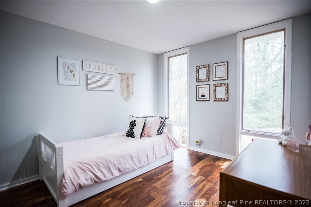 725 Barber Road Southern Pines, NC 28387 - Photo 42 of 50 a bedroom with a bed and wooden floor
