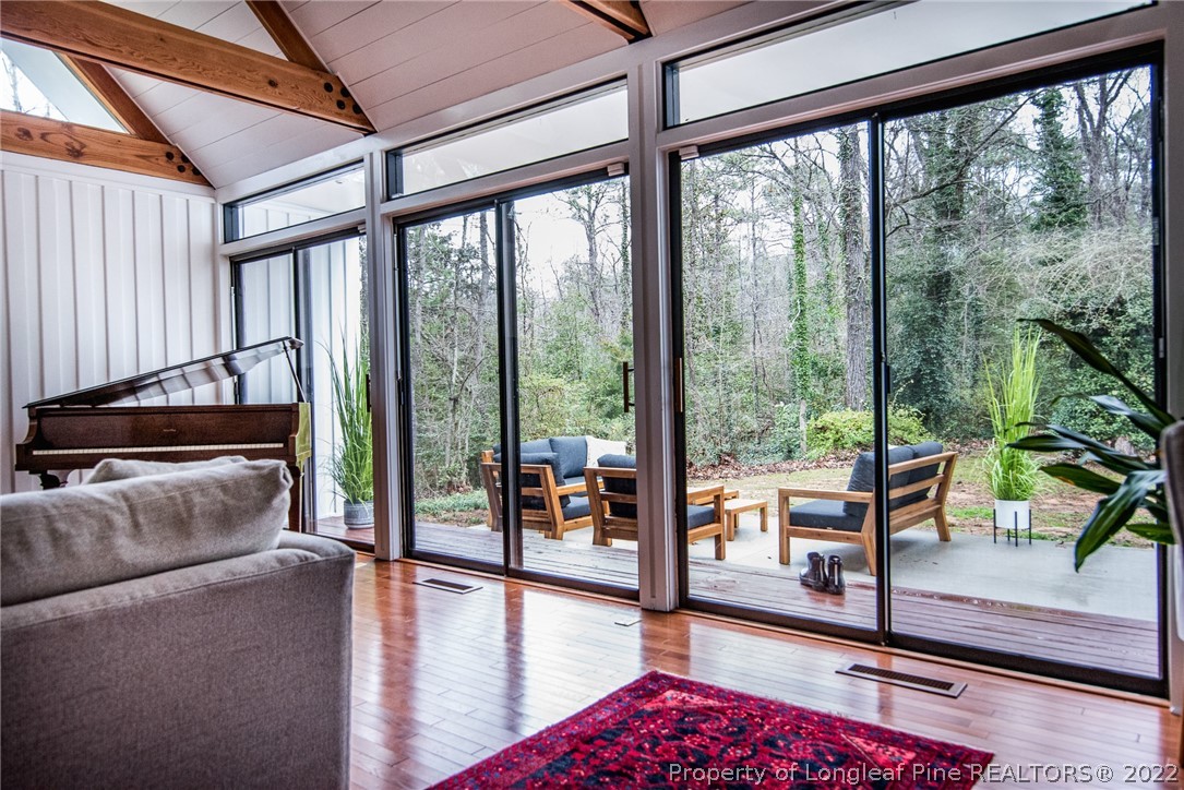 725 Barber Road Southern Pines, NC 28387 - Photo 8 of 50 a living room with furniture tv and a floor to ceiling window