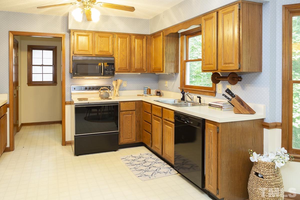 2817 Herring Boulevard Durham, NC 27704 - Photo 11 of 34 a kitchen with a sink stove and cabinets