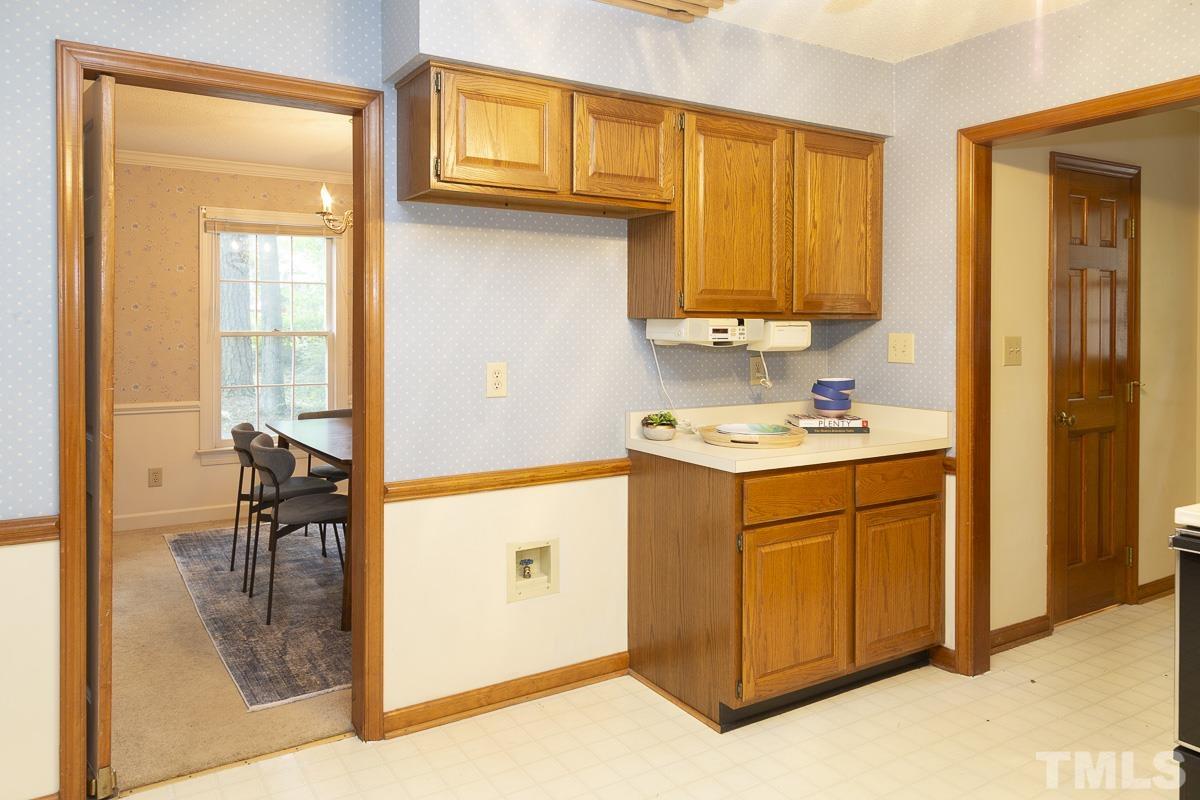 2817 Herring Boulevard Durham, NC 27704 - Photo 12 of 34 a kitchen with stainless steel appliances granite countertop a stove a sink and a refrigerator with wooden cabinets