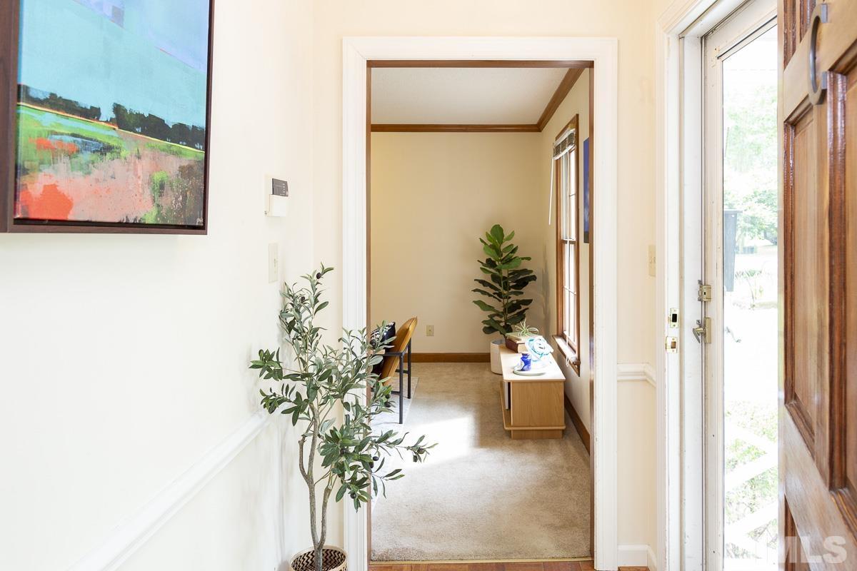 2817 Herring Boulevard Durham, NC 27704 - Photo 5 of 34 a view of a hallway with wooden floor and a potted plant
