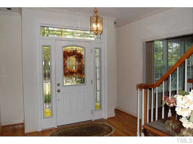 5100 Salem Ridge Road Holly Springs, NC 27540 - Photo 9 of 25 The foyer welcomes you with a front door with decorative glass, side and above transoms, warm hardwood floors, and a catwalk. Foyer